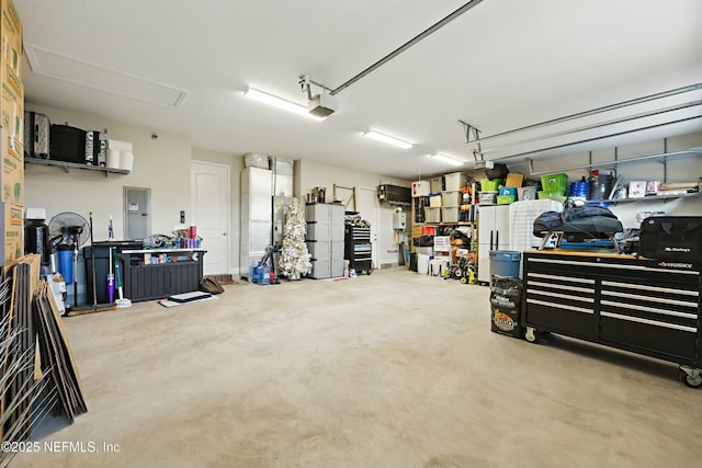 garage featuring refrigerator, a garage door opener, and freestanding refrigerator