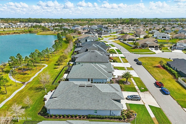 drone / aerial view with a residential view and a water view