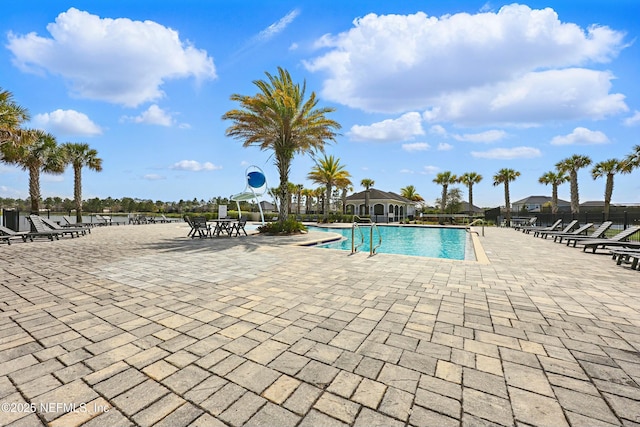 pool featuring a patio and fence