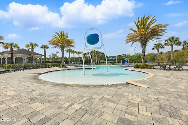 community pool featuring a patio and fence