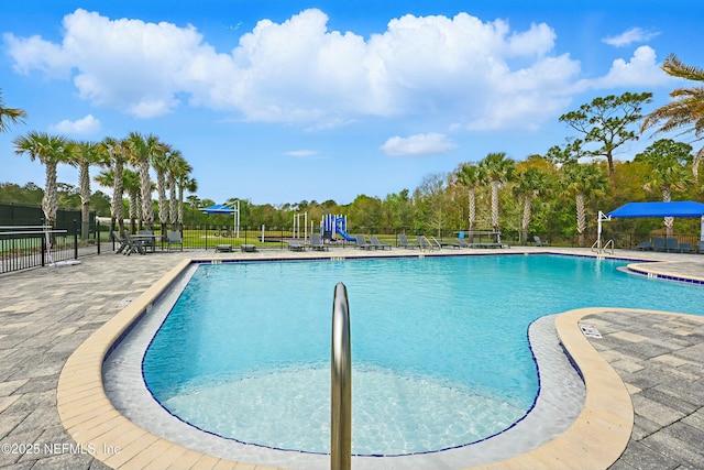 community pool featuring a patio area and fence