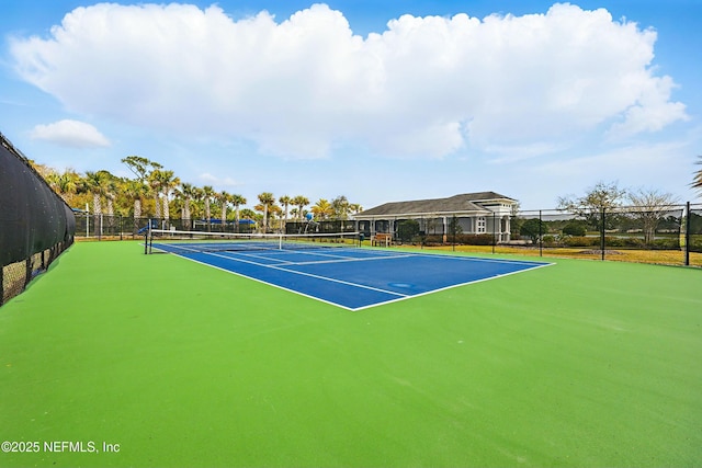 view of tennis court with fence