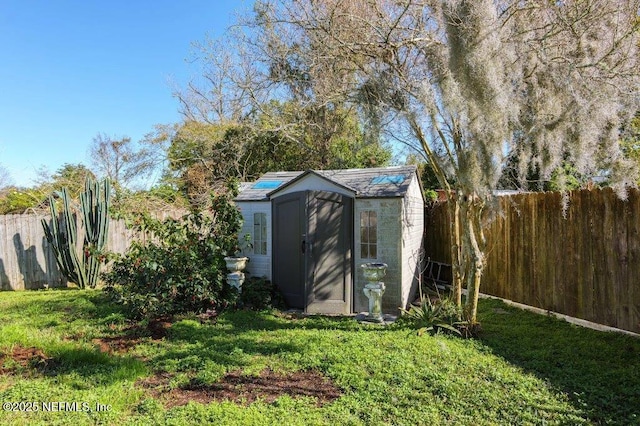 view of shed with a fenced backyard