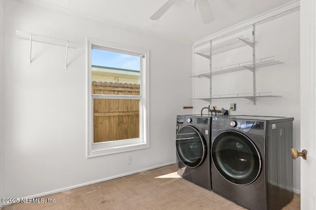 laundry room with baseboards, ceiling fan, laundry area, and washer and clothes dryer