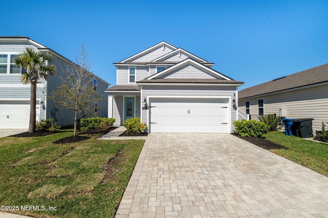 view of front of house with a garage, decorative driveway, and a front lawn