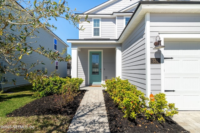 view of exterior entry featuring an attached garage