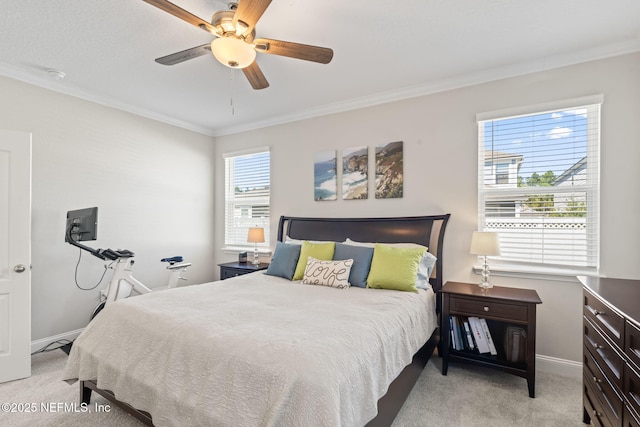 bedroom featuring ornamental molding, baseboards, and light carpet