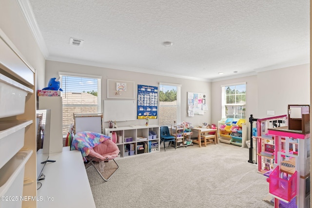 recreation room with visible vents, a textured ceiling, carpet floors, and ornamental molding