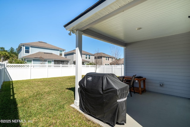 view of yard with a patio, a fenced backyard, and a residential view