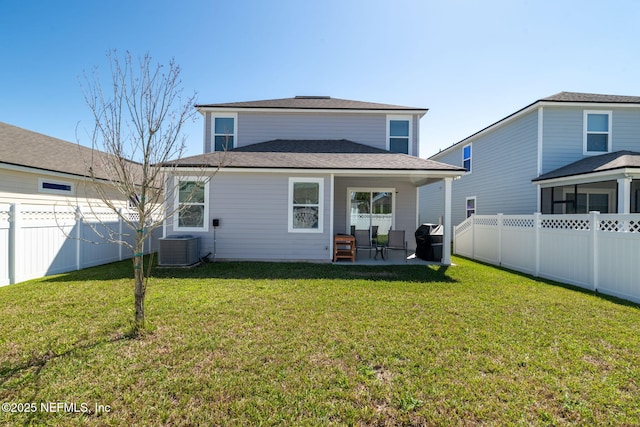 rear view of house with central AC unit, a lawn, a patio, and a fenced backyard