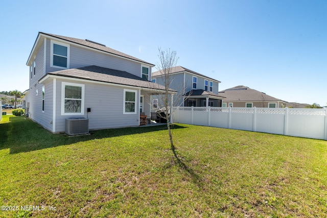 back of house featuring a yard, central air condition unit, a shingled roof, and a fenced backyard