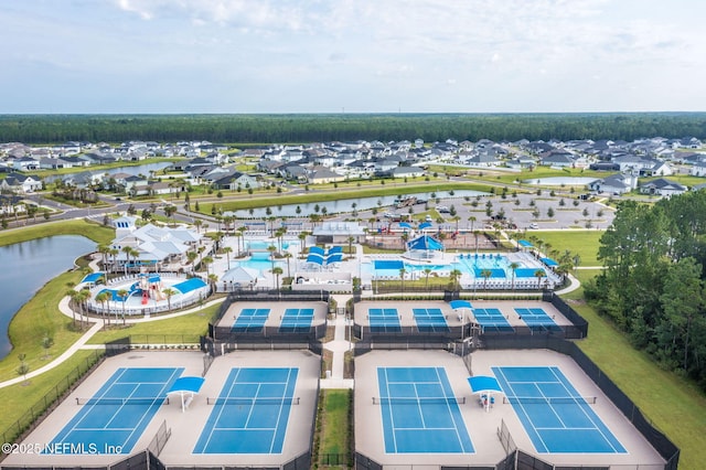 drone / aerial view featuring a residential view and a water view