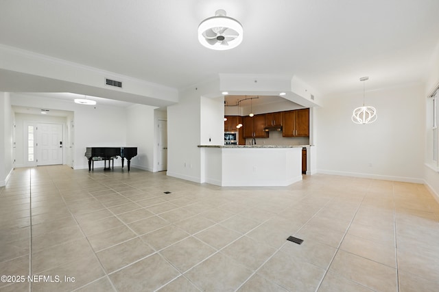 unfurnished living room with crown molding, light tile patterned floors, baseboards, and visible vents