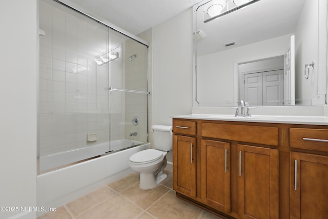 bathroom with visible vents, toilet, vanity, and tile patterned flooring