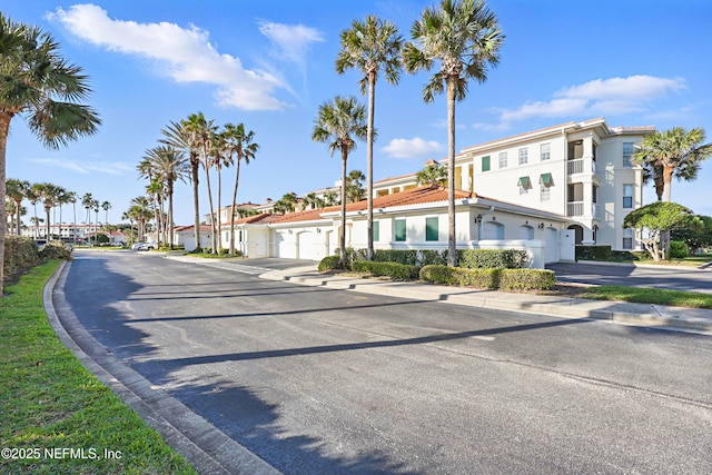 view of road with sidewalks, curbs, and a residential view