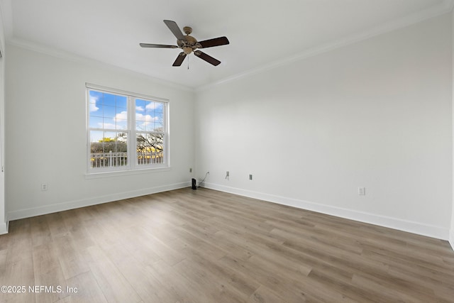 spare room with ornamental molding, ceiling fan, baseboards, and wood finished floors