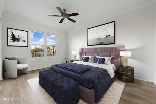 bedroom with crown molding, wood finished floors, and baseboards