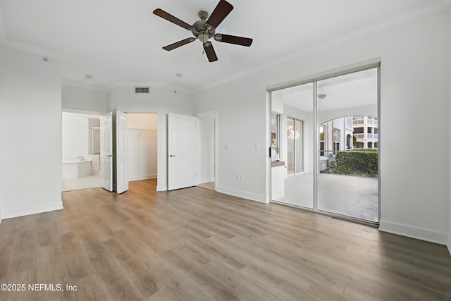 unfurnished bedroom featuring visible vents, crown molding, and wood finished floors