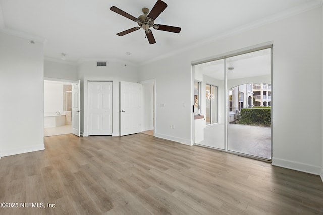 unfurnished bedroom with visible vents, wood finished floors, baseboards, and ornamental molding