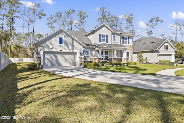 view of front of property featuring fence, stucco siding, concrete driveway, a front lawn, and stone siding