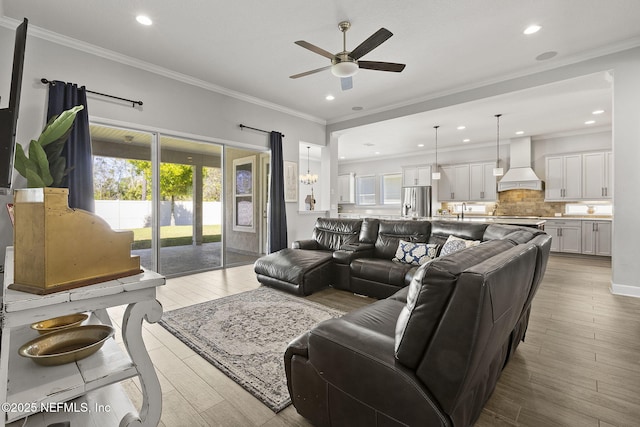 living room with recessed lighting, crown molding, ceiling fan, and wood finished floors