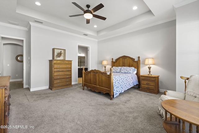 carpeted bedroom with a tray ceiling, baseboards, and visible vents