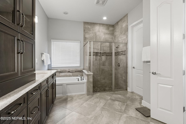 bathroom featuring vanity, visible vents, recessed lighting, a stall shower, and a bath