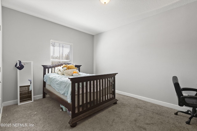 carpeted bedroom featuring baseboards