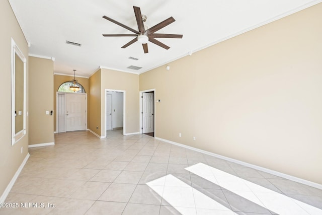 spare room featuring visible vents, light tile patterned flooring, crown molding, baseboards, and ceiling fan