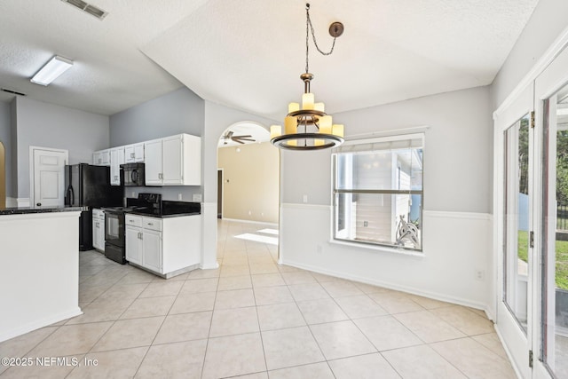 kitchen with visible vents, black appliances, dark countertops, light tile patterned floors, and a chandelier