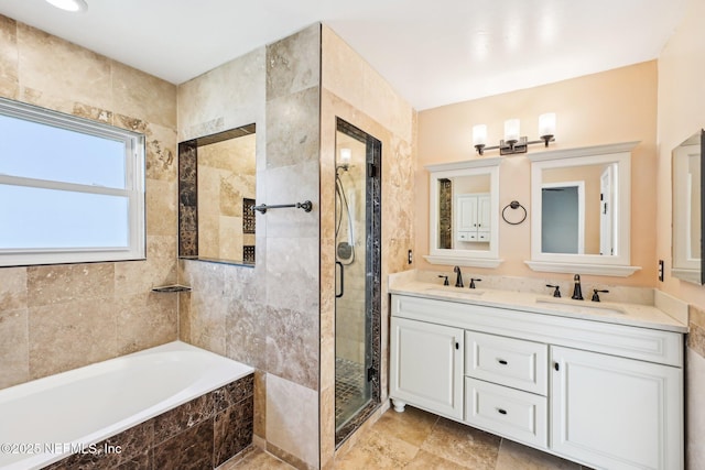 bathroom with a sink, a stall shower, a bath, and double vanity