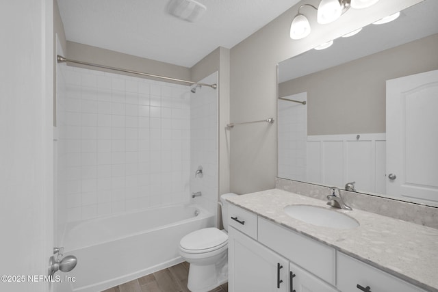 full bathroom with visible vents, toilet, wood finished floors, tub / shower combination, and vanity