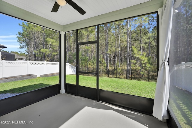 unfurnished sunroom with a healthy amount of sunlight and a ceiling fan