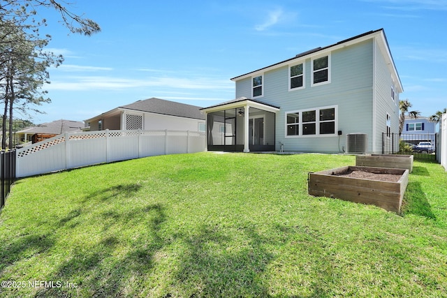 rear view of house with central AC, a fenced backyard, a yard, a vegetable garden, and a sunroom