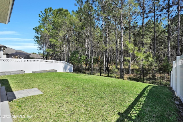 view of yard with a fenced backyard