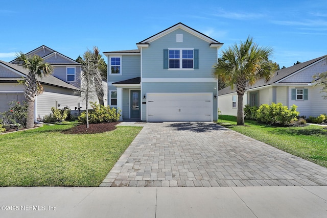 traditional home featuring a garage, decorative driveway, and a front yard