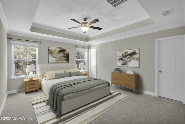 bedroom featuring visible vents, a raised ceiling, and carpet floors