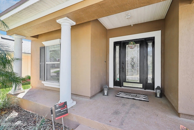 doorway to property with stucco siding