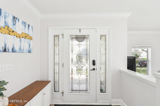 entryway with a textured ceiling, baseboards, and ornamental molding