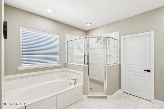 full bath with tile patterned flooring, a shower stall, and a whirlpool tub