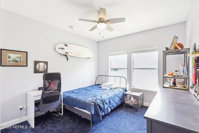 bedroom with a ceiling fan, carpet, baseboards, and a textured ceiling