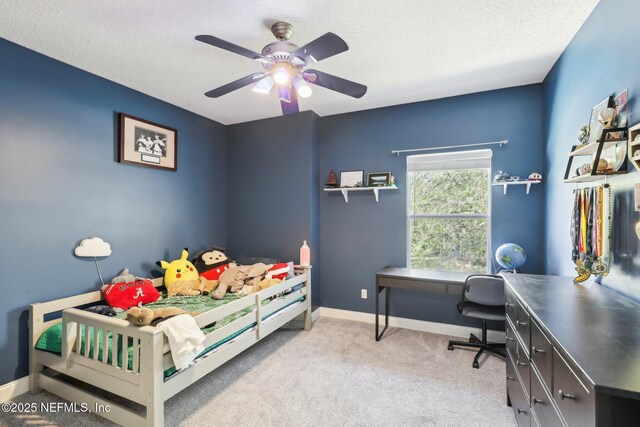 carpeted bedroom featuring ceiling fan, baseboards, and a textured ceiling