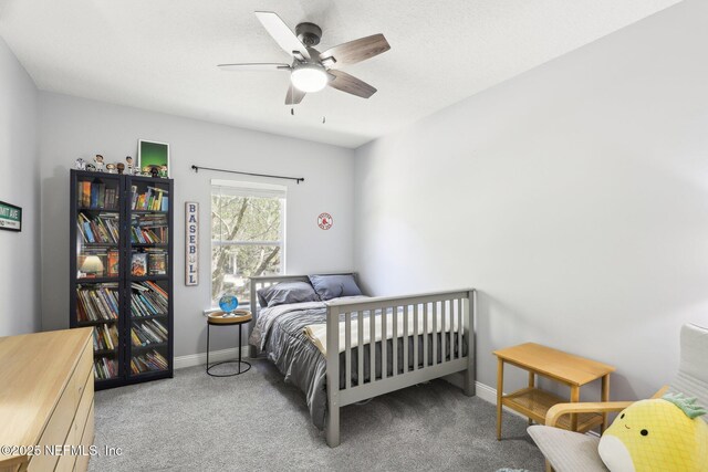 bedroom featuring baseboards, a ceiling fan, and carpet flooring