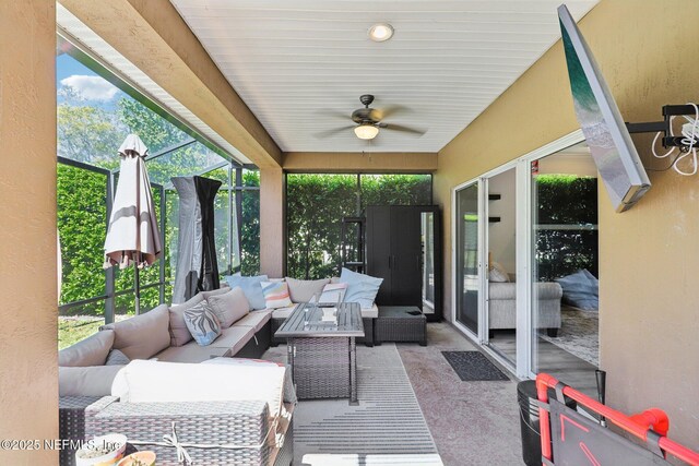 view of patio / terrace with glass enclosure, outdoor lounge area, and a ceiling fan