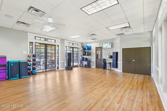 interior space with wood finished floors, french doors, visible vents, and a paneled ceiling