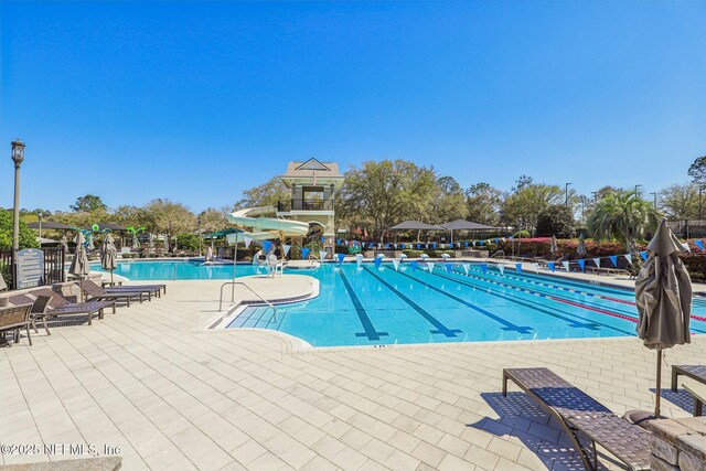 pool featuring a patio area and a water slide