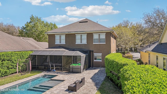 back of house with a patio, an outdoor pool, a lanai, and stucco siding