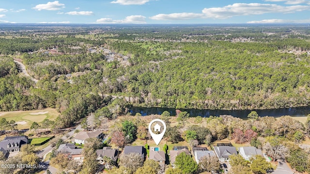 aerial view featuring a wooded view and a water view