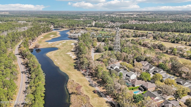 birds eye view of property featuring a forest view and a water view