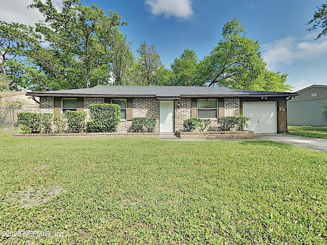 single story home with brick siding, driveway, a front lawn, and an attached garage